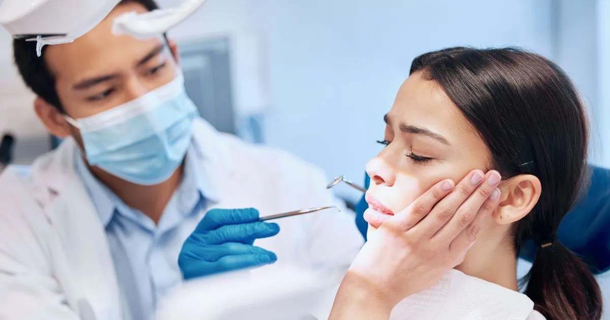 Dentist performing root canal therapy on a distressed patient in Las Vegas, NV